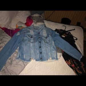 A cropped blue ripped jean jacket
